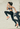 Frau beim dynamischen Outdoor-Workout, springt energisch vor Betonwand – Symbol für Motivation im Sport und körperliche Leistungsfähigkeit