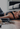 Frau liegt erschöpft nach intensivem Workout im Wohnzimmer – Symbol für Übertraining und fehlende Regeneration